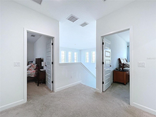 hallway with light carpet