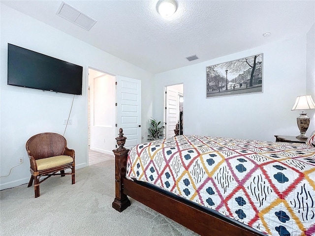 bedroom featuring a textured ceiling and carpet flooring