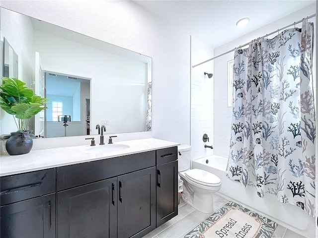 full bathroom featuring vanity, shower / tub combo with curtain, and toilet