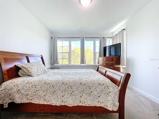 bedroom featuring a textured ceiling and carpet floors