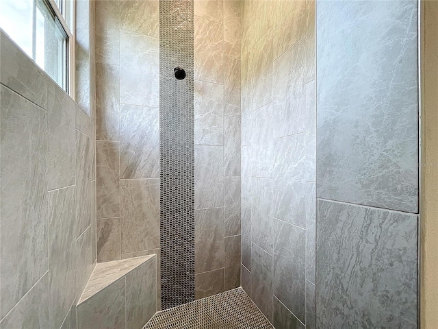 bathroom with tiled shower