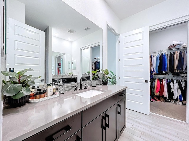 bathroom with vanity and hardwood / wood-style flooring