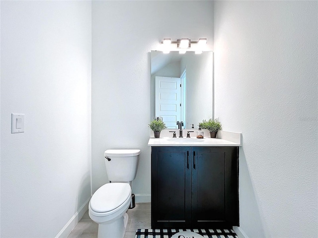 bathroom with vanity, toilet, and tile patterned flooring