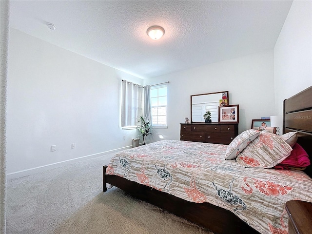 carpeted bedroom featuring a textured ceiling