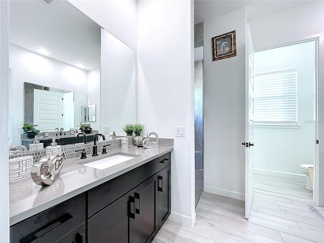 bathroom with vanity, hardwood / wood-style flooring, and toilet