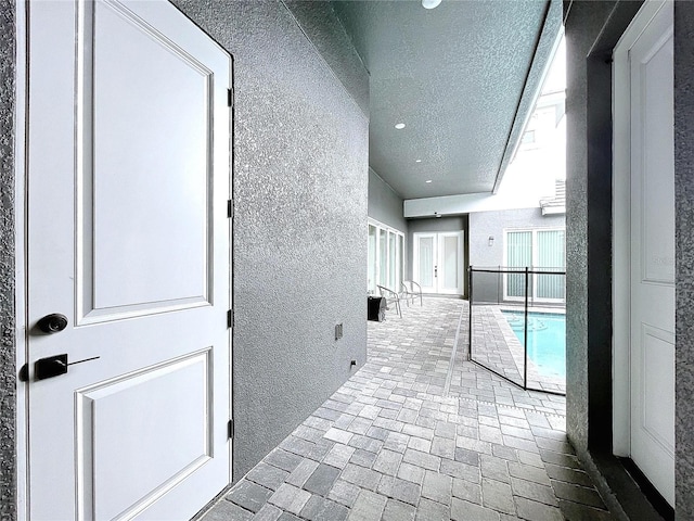 hallway with a textured ceiling