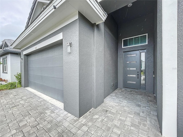 doorway to property featuring a garage