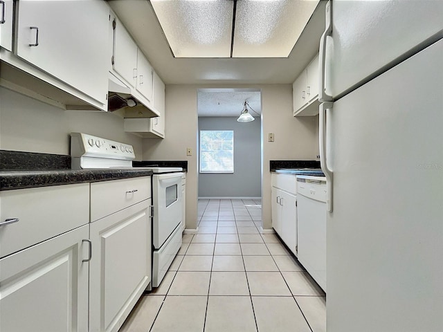 kitchen featuring white cabinets, light tile patterned floors, white appliances, and a textured ceiling