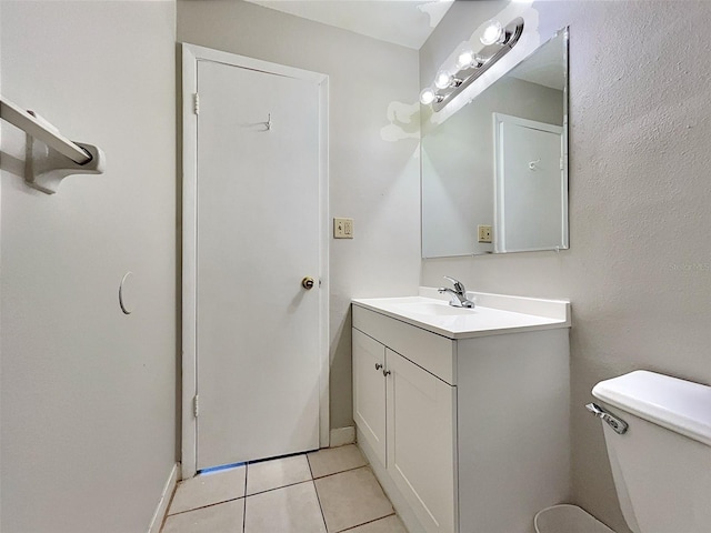 bathroom featuring tile patterned flooring, vanity, and toilet