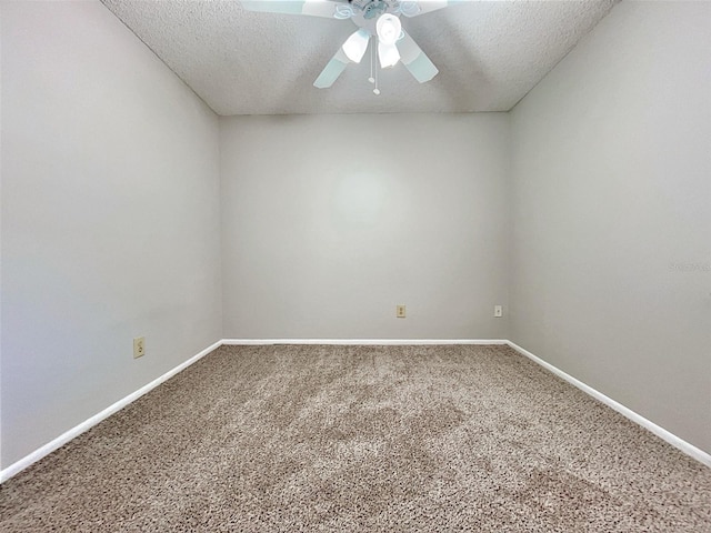 carpeted spare room featuring ceiling fan and a textured ceiling