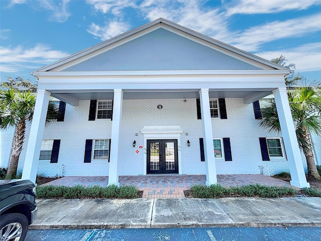 greek revival house featuring french doors