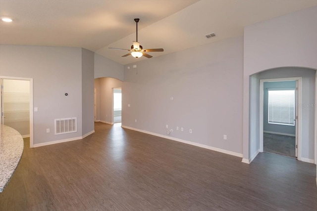 spare room featuring a wealth of natural light, ceiling fan, high vaulted ceiling, and dark hardwood / wood-style flooring