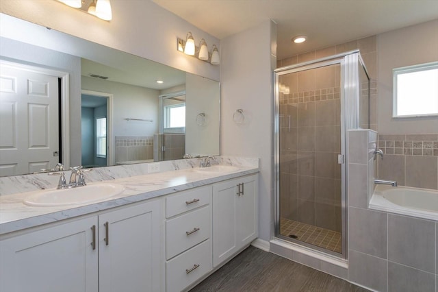 bathroom featuring vanity, hardwood / wood-style floors, and independent shower and bath