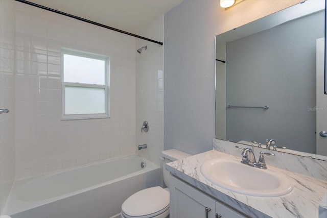 full bathroom with vanity, toilet, and tiled shower / bath