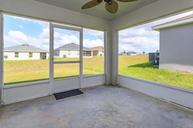 unfurnished sunroom featuring ceiling fan