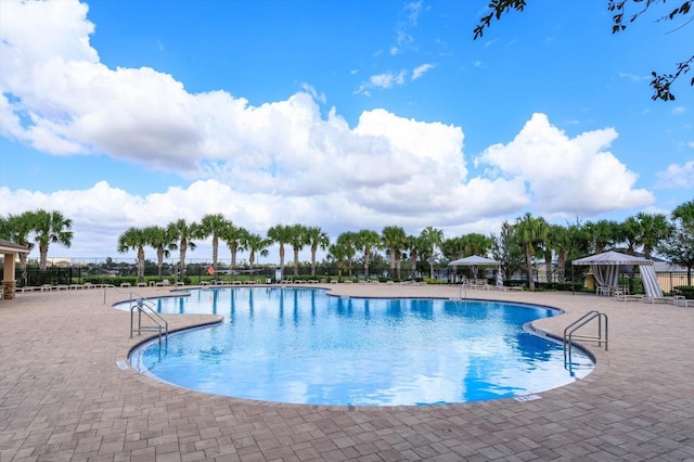 view of swimming pool with a gazebo and a patio area