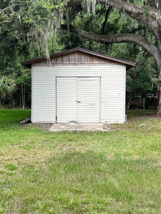 view of outbuilding with a lawn