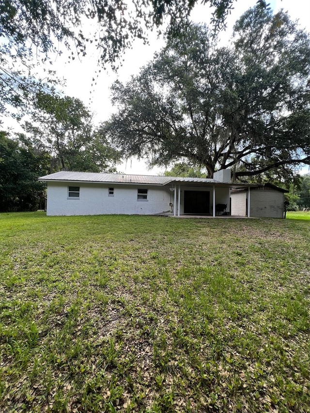 back of house with a yard