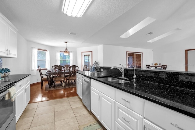 kitchen featuring white cabinetry, light tile patterned floors, stainless steel appliances, and sink