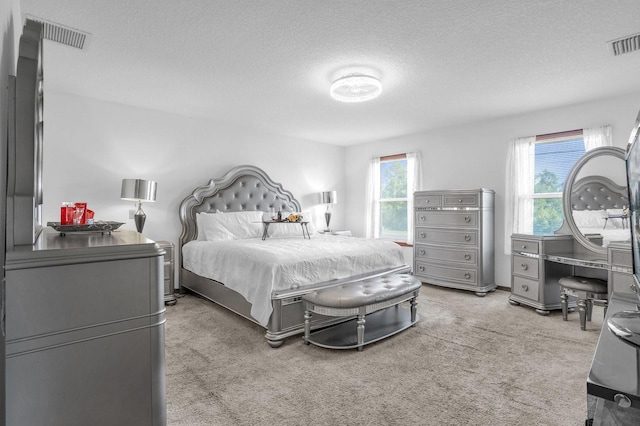 carpeted bedroom featuring a textured ceiling