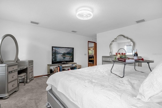 carpeted bedroom featuring a textured ceiling