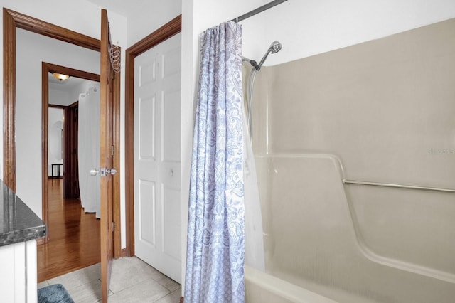 bathroom featuring shower / tub combo with curtain and wood-type flooring