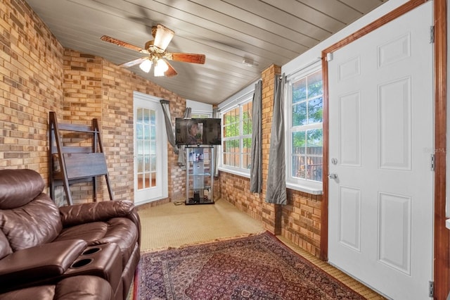 living room with brick wall, wood ceiling, lofted ceiling, and ceiling fan