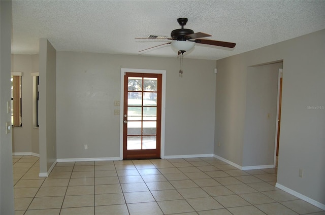 unfurnished room featuring ceiling fan, a textured ceiling, and light tile patterned floors