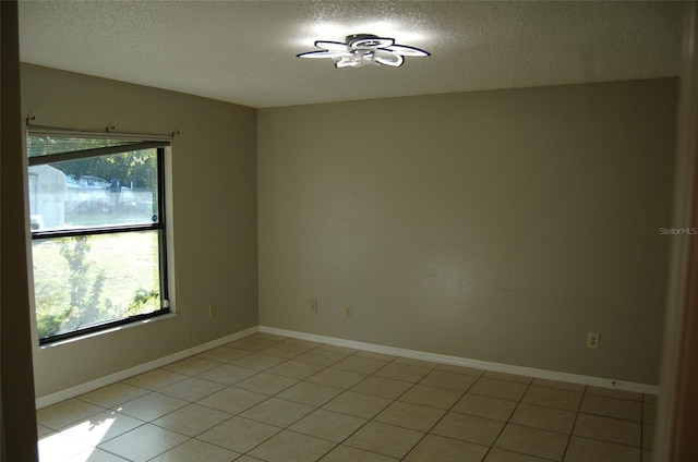 unfurnished room featuring ceiling fan, a textured ceiling, and light tile patterned floors