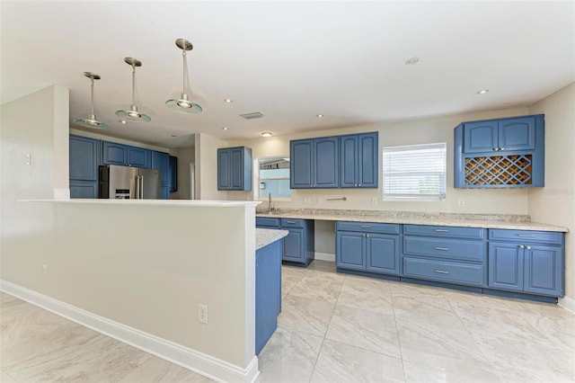 kitchen with blue cabinets, stainless steel fridge with ice dispenser, and pendant lighting