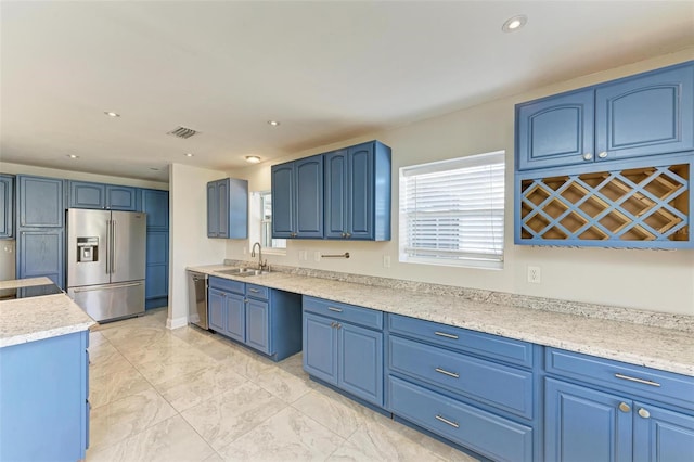 kitchen with blue cabinets, sink, and appliances with stainless steel finishes