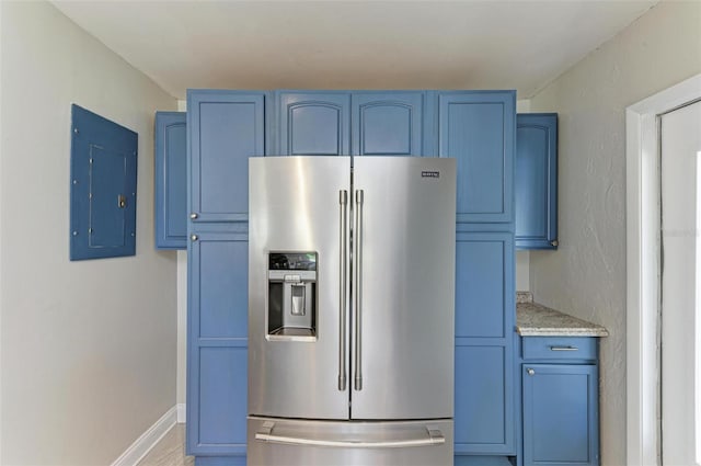 kitchen with blue cabinetry, electric panel, and stainless steel fridge with ice dispenser