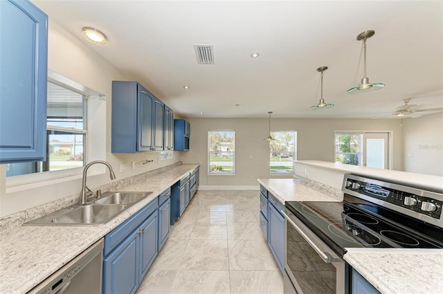 kitchen featuring hanging light fixtures, ceiling fan, stainless steel appliances, sink, and blue cabinets