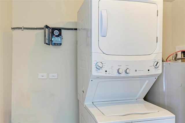 washroom featuring stacked washer / dryer