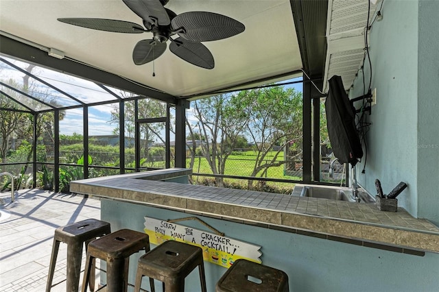 unfurnished sunroom featuring ceiling fan