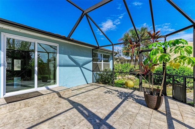 view of patio with glass enclosure