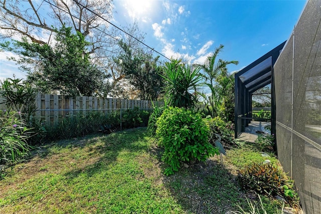 view of yard featuring glass enclosure