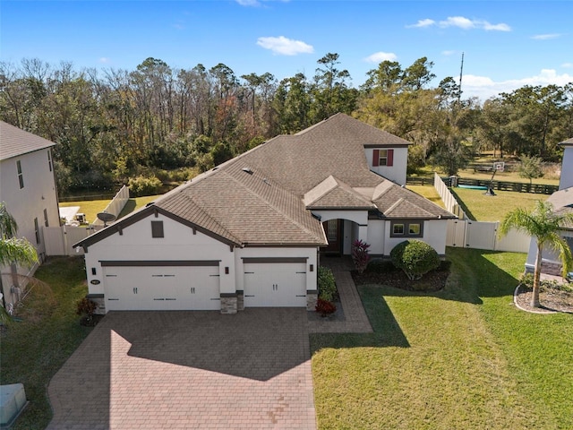 view of front of property with a garage and a front lawn