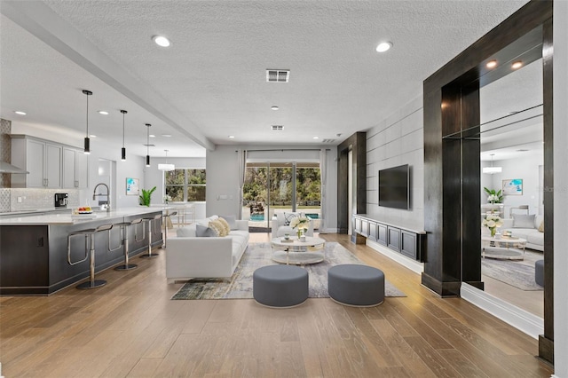 living room with wood-type flooring and a textured ceiling