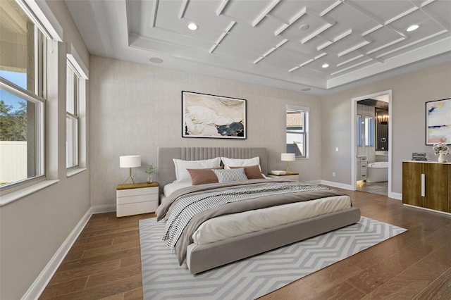 bedroom featuring coffered ceiling and connected bathroom