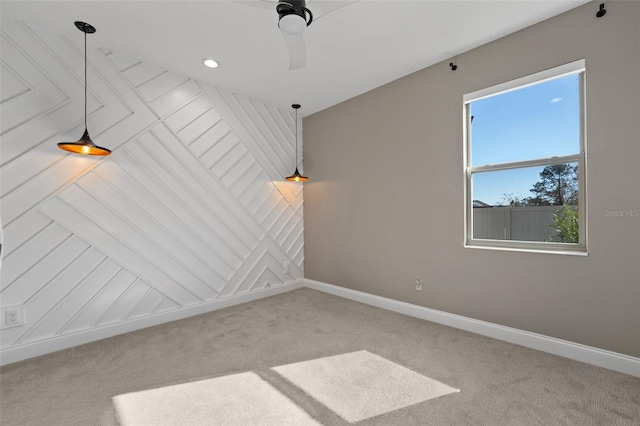 carpeted empty room featuring ceiling fan