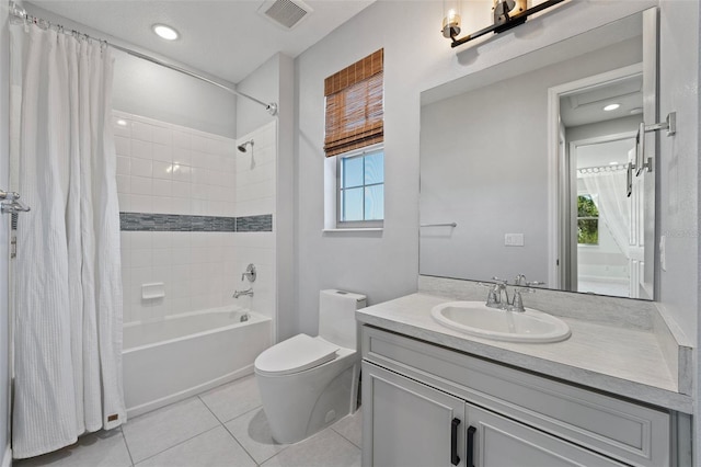 full bathroom with shower / tub combo, vanity, tile patterned flooring, and a wealth of natural light