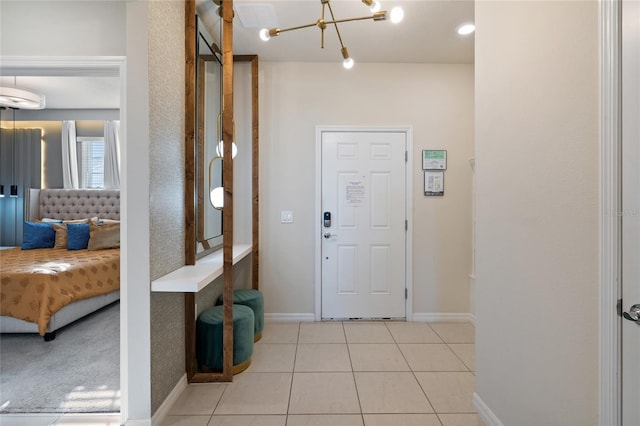 foyer entrance featuring a notable chandelier, light tile patterned flooring, and an AC wall unit