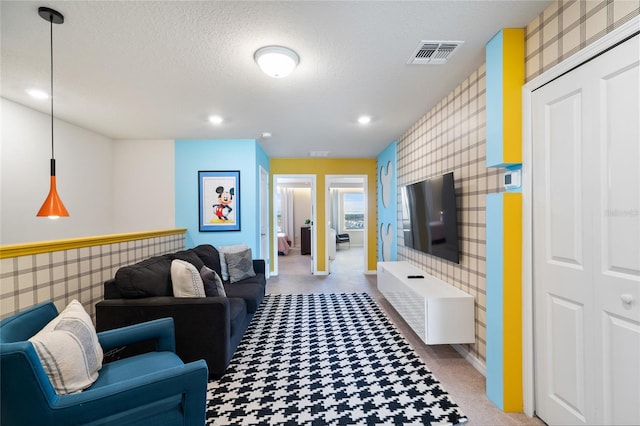 living room featuring carpet floors and a textured ceiling