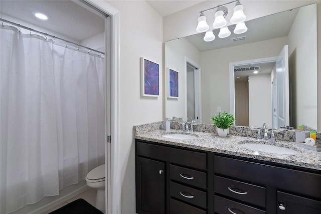 full bathroom featuring toilet, shower / tub combo with curtain, and vanity