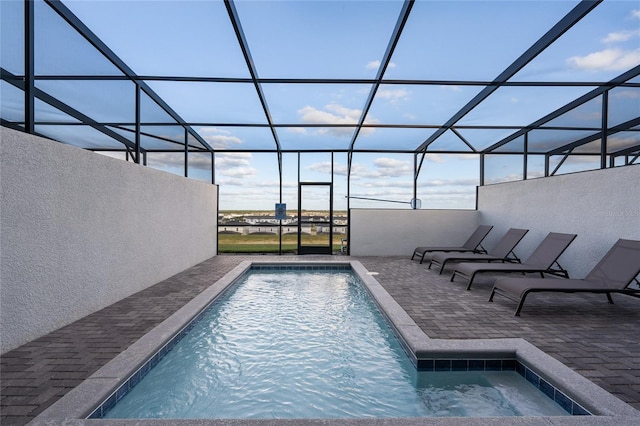 view of pool with a patio and a lanai