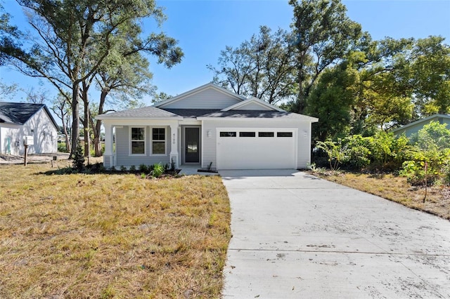 view of front of home with a front lawn and a garage