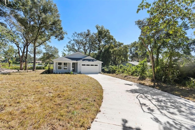 ranch-style house featuring a front yard and a garage