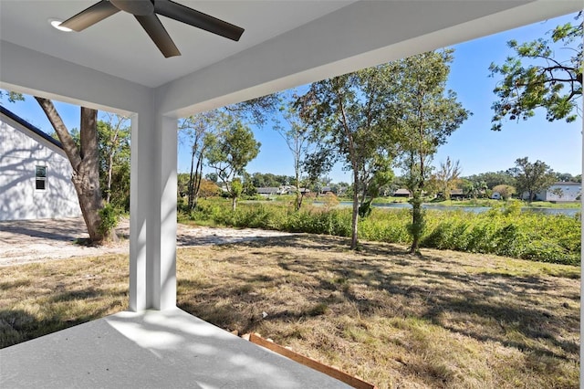 4190 Rossmore Dr, Orlando, FL 32810 - view of grassy yard featuring a ceiling fan and a water view