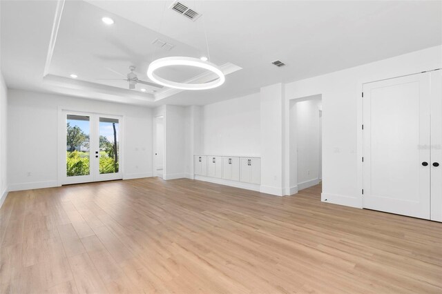 4190 Rossmore Dr, Orlando, FL 32810 - unfurnished room featuring a tray ceiling, light wood-style flooring, a ceiling fan, baseboards, and recessed lighting